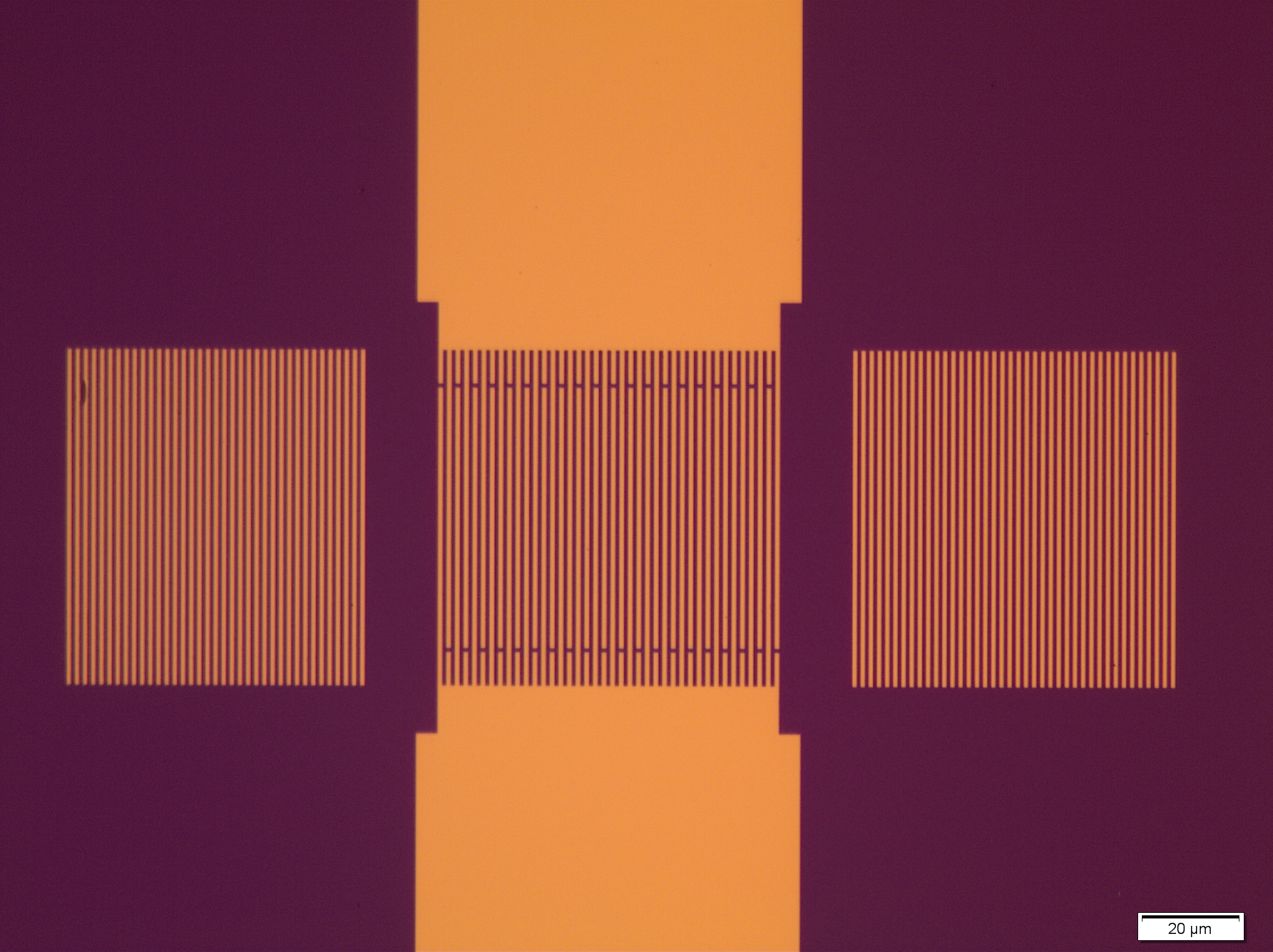 Optical image of a fabricated AlN-on-silicon one-port resonator with a central IDT, reflector gratings and contact pads